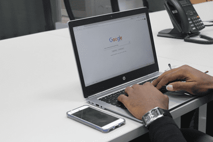 A man using Google’s search engine on their laptop