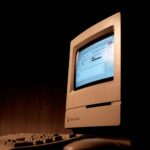Close-up of a Macintosh Classic computer, showcasing vintage technology and nostalgia.