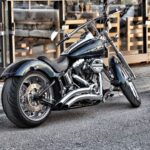 A sleek Harley-Davidson motorcycle parked on a city street, showcasing chrome detailing.