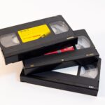 Three vintage VHS video cassette tapes stacked on a white background.