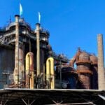 A view of the historic Völklingen Ironworks industrial facility under a clear blue sky.