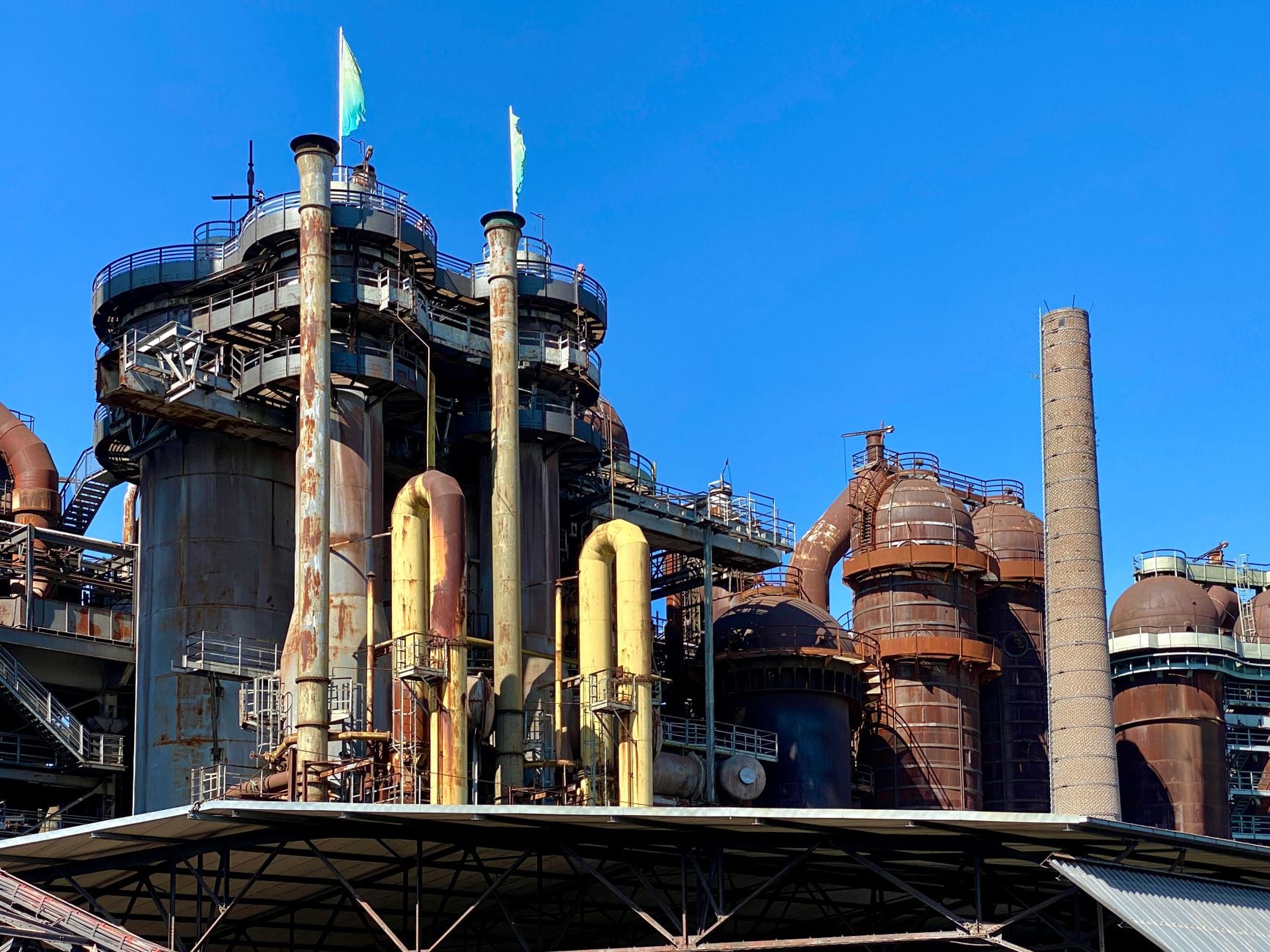 A view of the historic Völklingen Ironworks industrial facility under a clear blue sky.